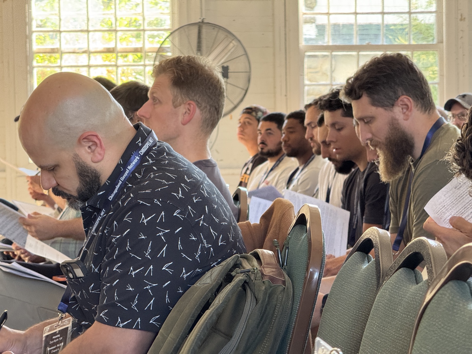 Men taking notes during a teaching session
